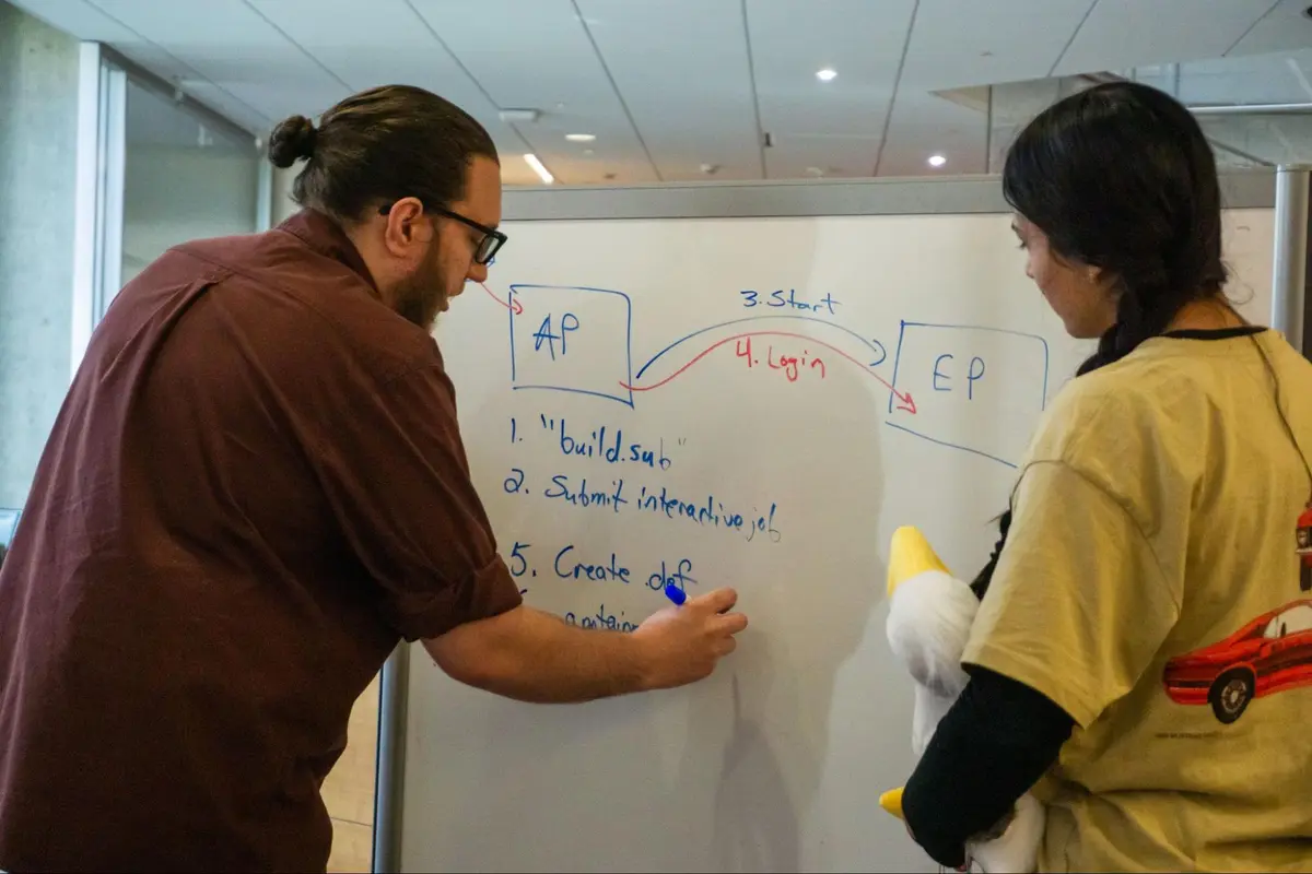 People packed into a classroom watching a presentation on AlphaFold3