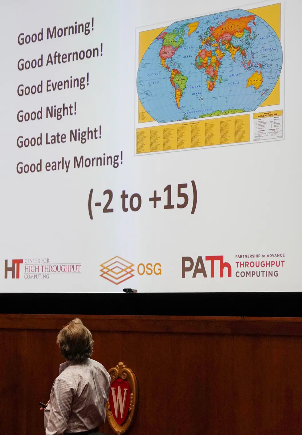 Miron Livny looks back at his presentation slide, which welcomes attendees from different timezones.