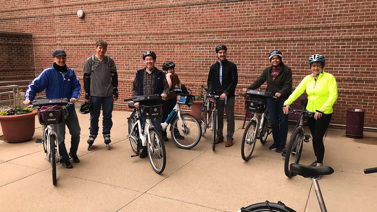 HTCondor Week Attendees gathered on their bikes, smiling for a picture