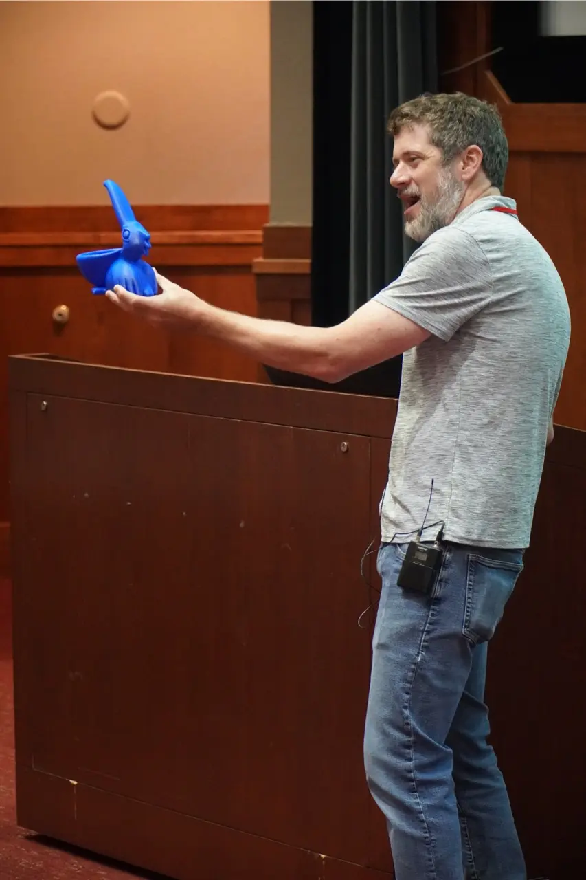 Brian Bockelman holding the new HTC24 award